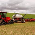 picture of red farm equipment in a field in Wyoming USA